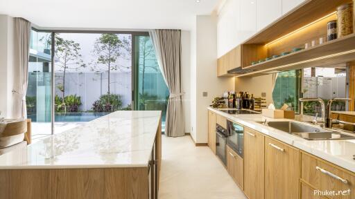 Modern kitchen with large windows and pool view