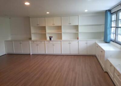 spacious living area with built-in white cabinetry