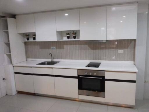 Modern white kitchen with cabinetry and appliances