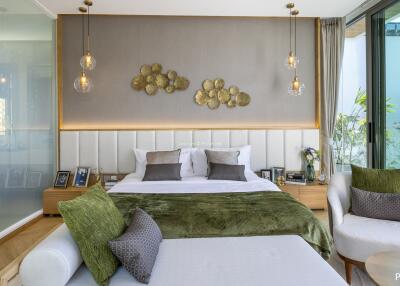 Modern bedroom with large bed, decorative lighting, and greenery view