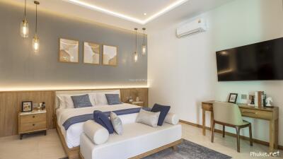 Modern bedroom with a king-sized bed, decorative lights, air conditioning, and a wall-mounted TV