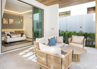 A cozy outdoor seating area connected to an interior view of a modern living room