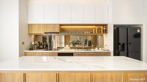 Modern kitchen with wooden cabinets and marble countertops