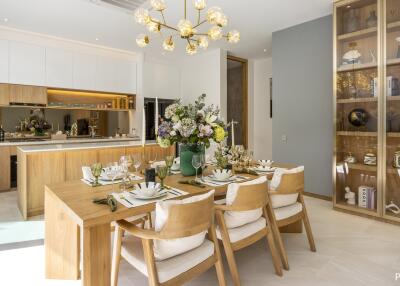 Modern dining area with wooden table and chairs, adjacent to a stylish kitchen