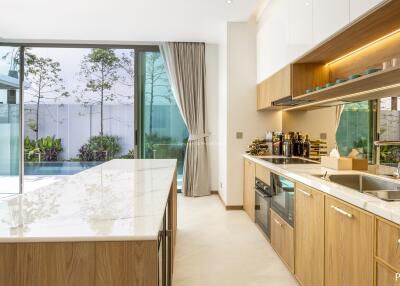 Modern kitchen with island and pool view