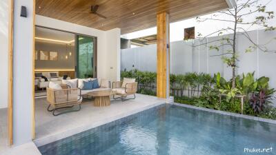 Covered patio with seating area and swimming pool