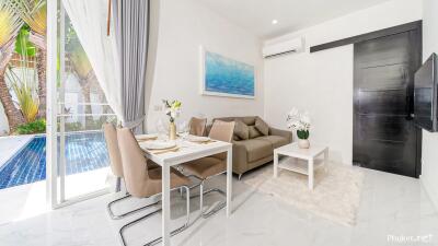 Modern living room with dining area and view of the pool