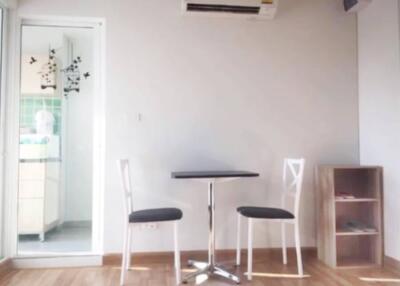 Minimalist dining area with a small table and two chairs