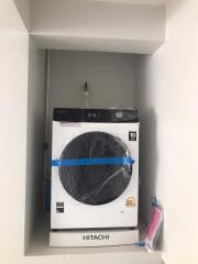 Laundry area with a Hitachi washing machine