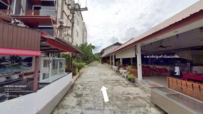 Exterior view of buildings and pathway with restaurant