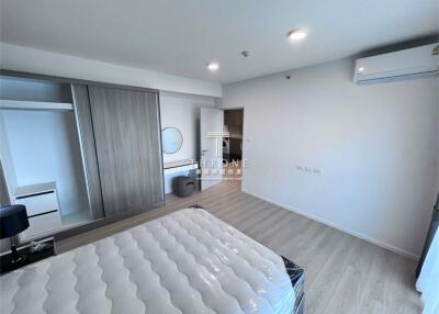 Modern bedroom with ample lighting and wooden flooring