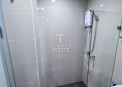 Modern bathroom with glass shower and tiled walls