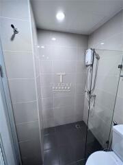 Modern bathroom with glass shower and tiled walls