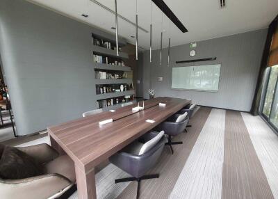 Modern conference room with large wooden table and chairs