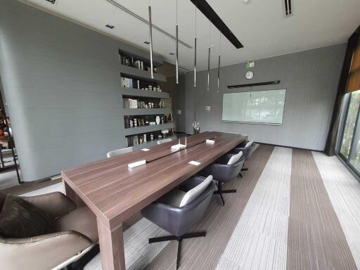 Modern conference room with large wooden table and chairs