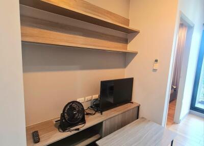 Living area with TV and shelves