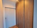 Hallway with wooden floor and built-in wardrobe