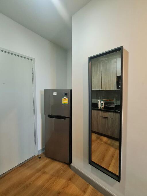 Modern kitchen with refrigerator and full-length mirror