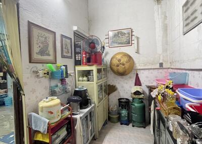 A compact cluttered kitchen space with various household items