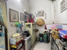 A compact cluttered kitchen space with various household items