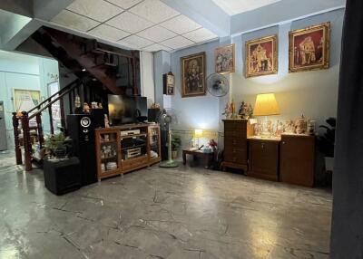 Spacious living room with staircase and decorated walls