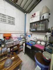 Compact kitchen with storage spaces and dish racks