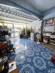 covered living area with blue patterned floor tiles and household items