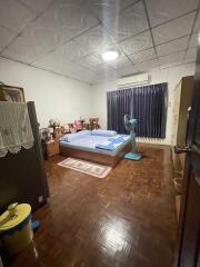 Cozy bedroom with double bed and wooden flooring