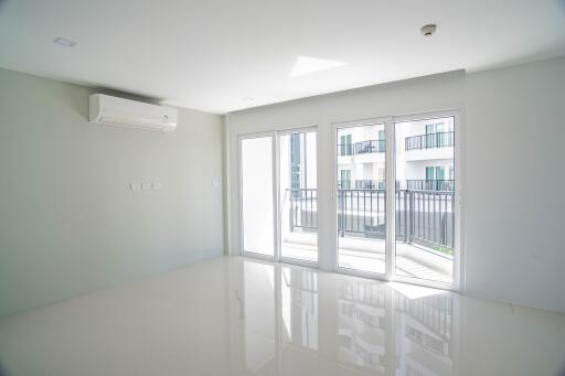 Living room with large windows and balcony access