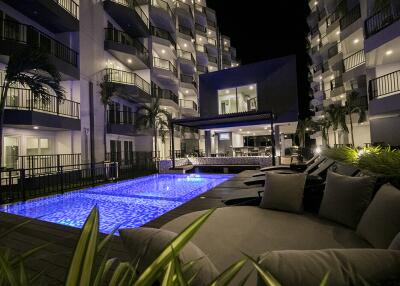 Night view of apartment buildings with illuminated swimming pool