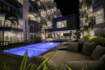 Night view of apartment buildings with illuminated swimming pool