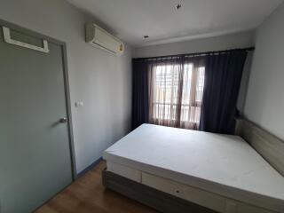 Bedroom with bed, air conditioner, and window