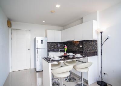 Modern white kitchen with breakfast bar and high stools