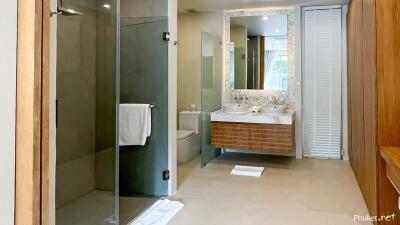 Modern bathroom with double sinks and glass shower