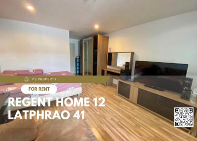 Spacious bedroom with wooden flooring, two beds, ample storage and a TV
