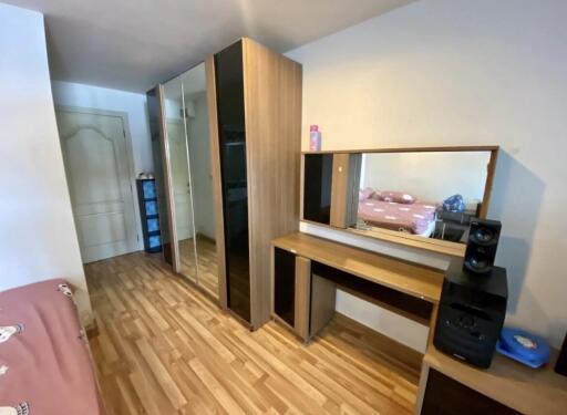 Bedroom with wooden floor, wardrobe, and dresser