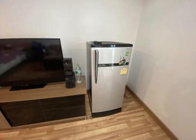Living area with television and mini refrigerator