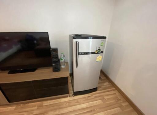 Living area with television and mini refrigerator