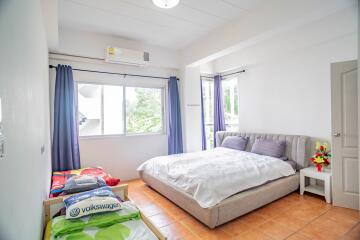 Spacious bedroom with a large bed and ample natural light