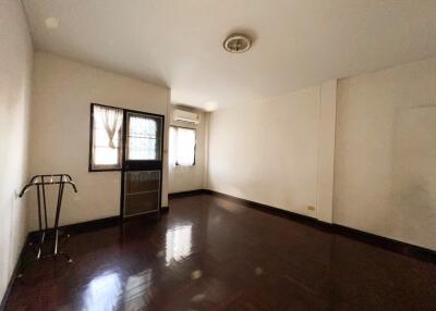 Empty room with hardwood floor and air conditioner