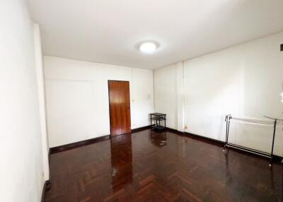 Empty room with wooden floor and white walls.