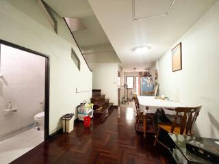 Dining area with a view of a staircase and adjacent bathroom