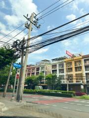 Street view of buildings surrounded by greenery