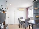 Modern dining area with glass shelves and AC