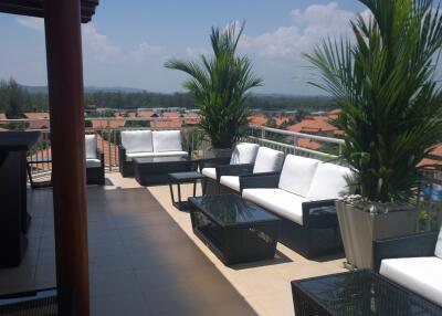 Sunny outdoor terrace with seating area and views