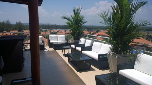 Sunny outdoor terrace with seating area and views