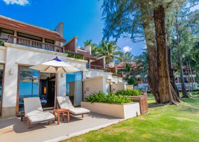 Exterior view of the building with garden and sun loungers