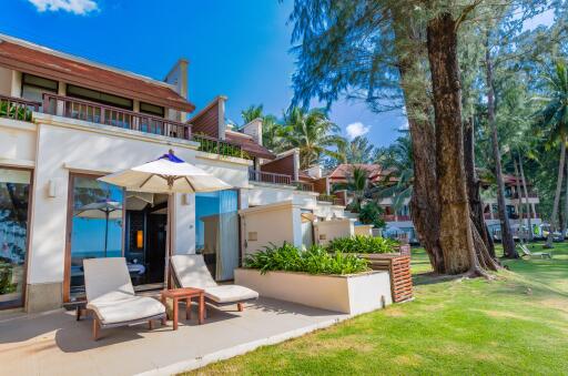 Exterior view of the building with garden and sun loungers