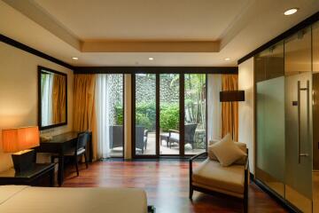 Modern bedroom with sliding glass doors to a garden