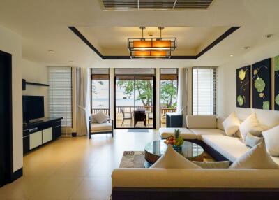 Spacious living room with modern furnishings and a view of an outdoor patio